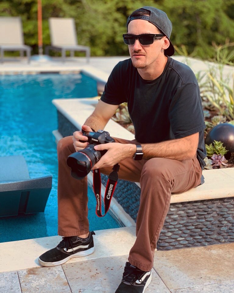 Ryan Dundas seated with a Canon cinema camera