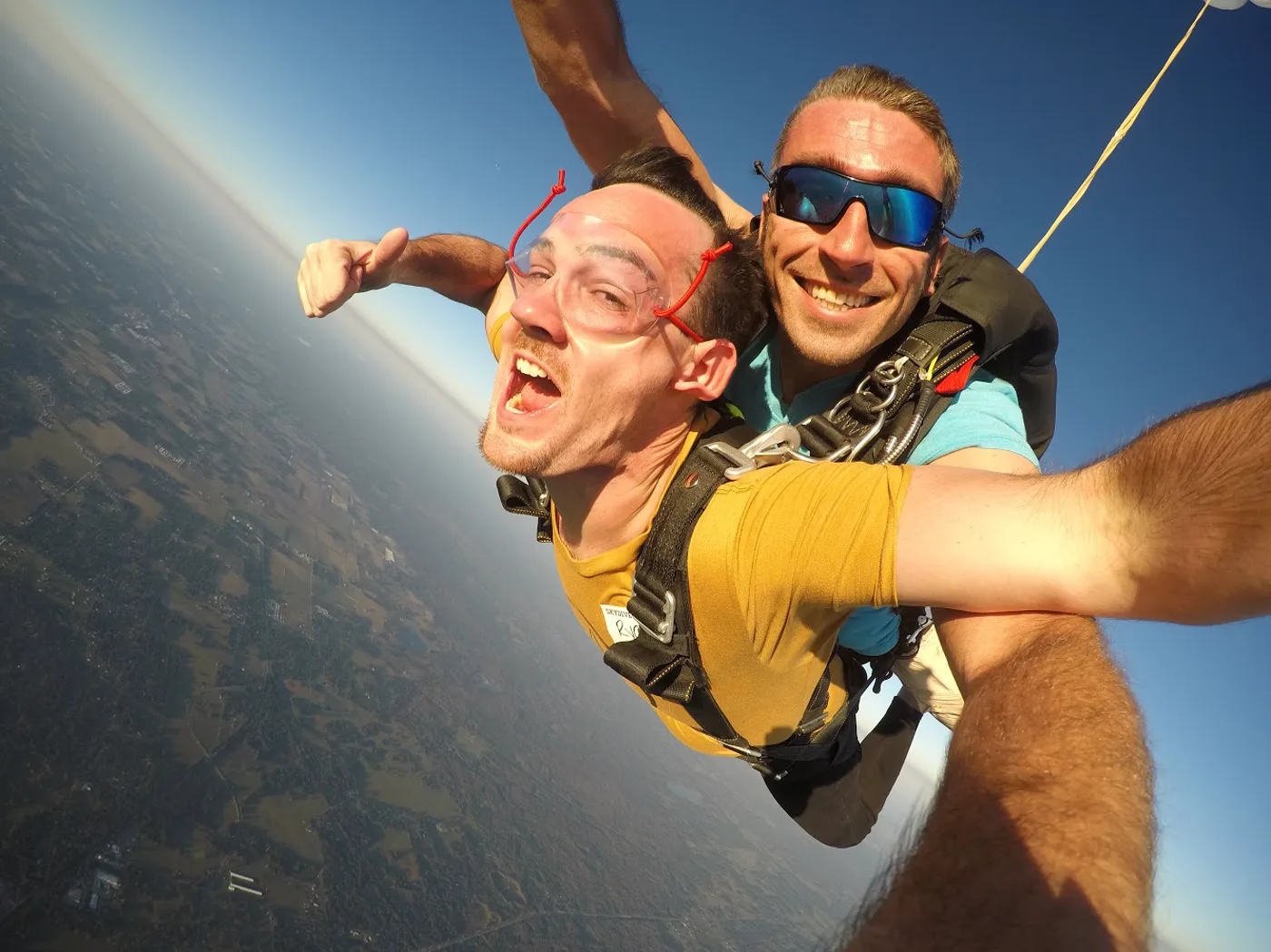 Ryan grinning during a tandem skydive