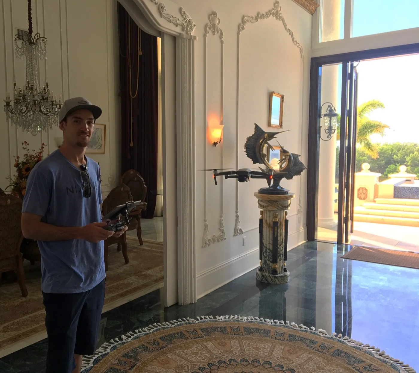 Ryan piloting a DJI drone inside an ornate marble foyer