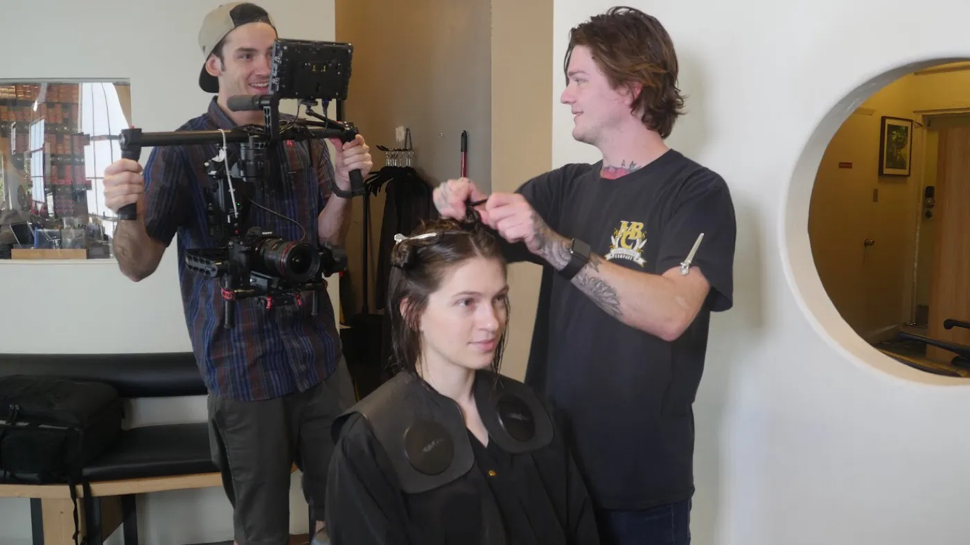 Filming a hair-styling session in a salon with a gimbal-mounted camera